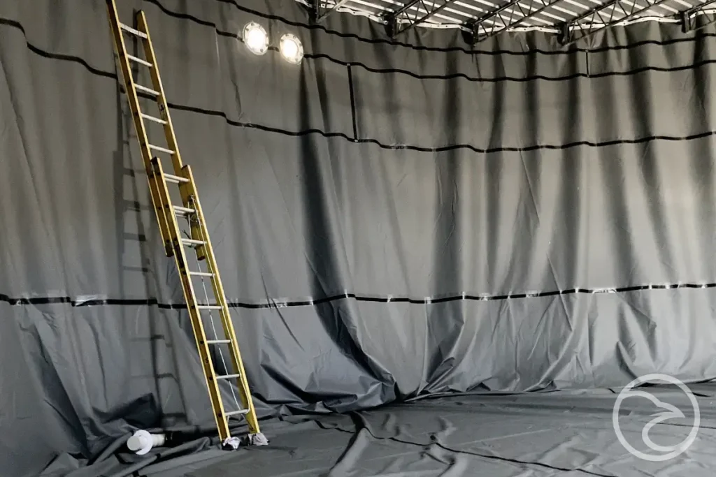 Pit liner material undergoing tensile and puncture resistance tests