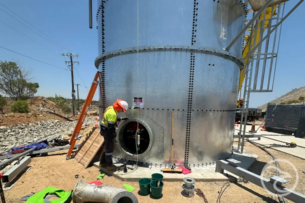 Worker conducting water tank cleaning after inspection