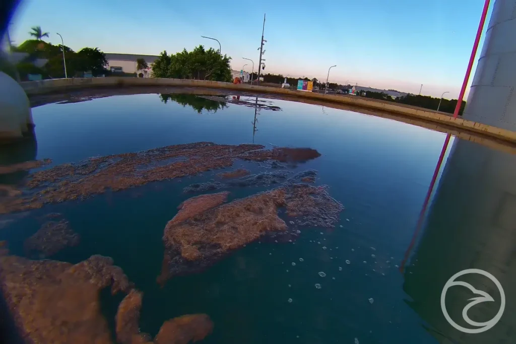 Sediment buildup at the bottom of a water tank during inspection