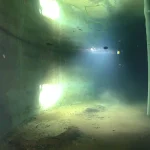 Remote underwater drone operating inside a confined storage tank