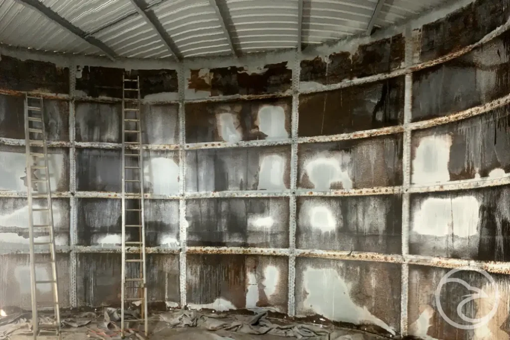 Rust and pitting on steel industrial tank surface