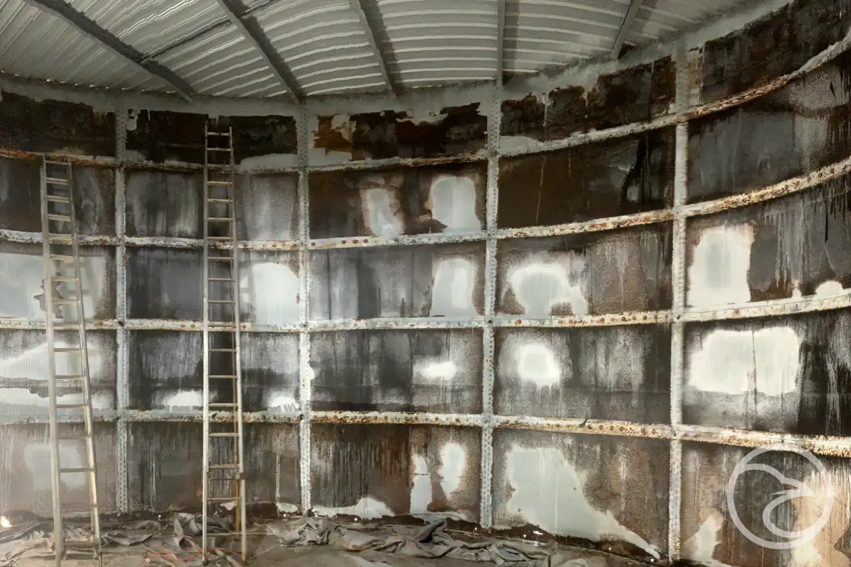 Rust and pitting on steel industrial tank surface